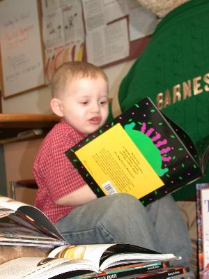 Little me "reading" at Boston Children's Primary Care Center. That book? A gift from the Reach out and Read program - made possible by donors like you!